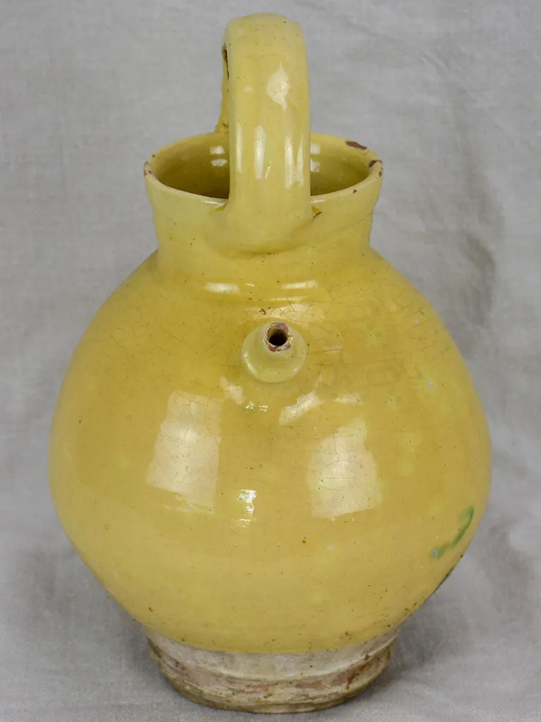 Antique French water pitcher with pale yellow glaze